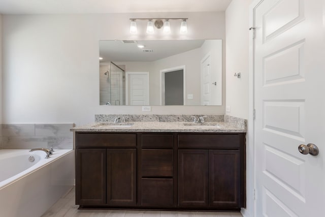 bathroom with plus walk in shower and vanity