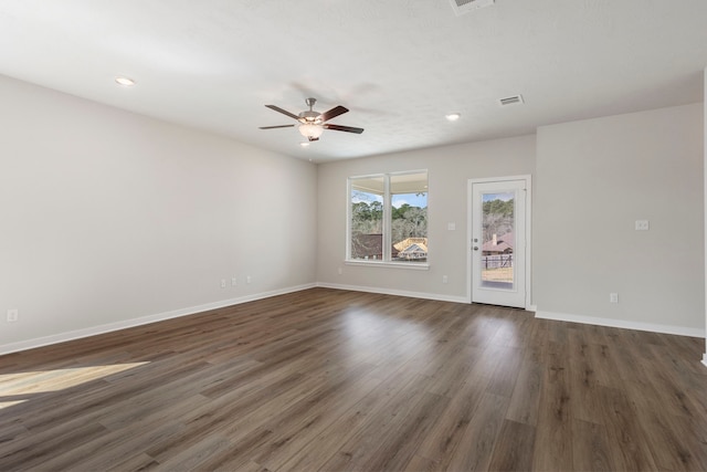 unfurnished living room featuring dark hardwood / wood-style floors and ceiling fan