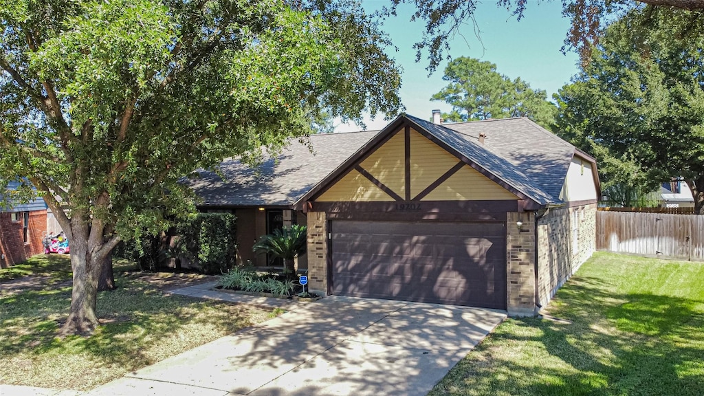 view of front of property featuring a garage and a front yard