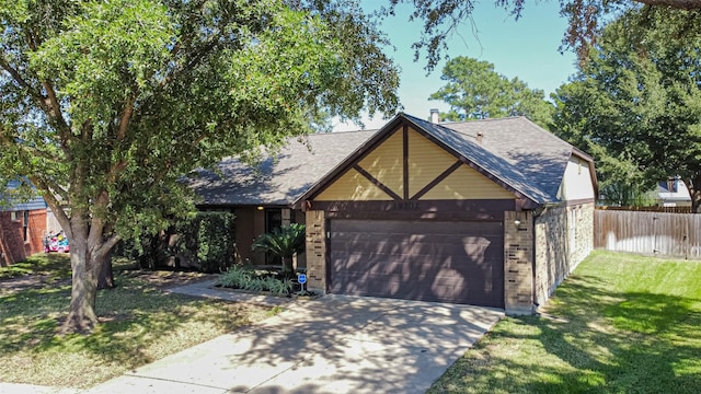 view of front of property featuring a garage and a front yard