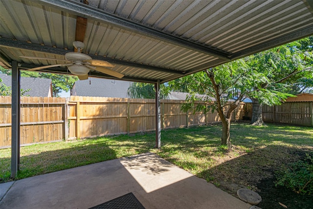 view of yard with ceiling fan and a patio