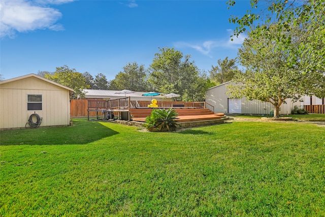 view of yard with a wooden deck and a shed