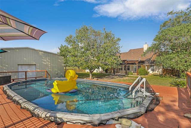 view of swimming pool featuring a wooden deck