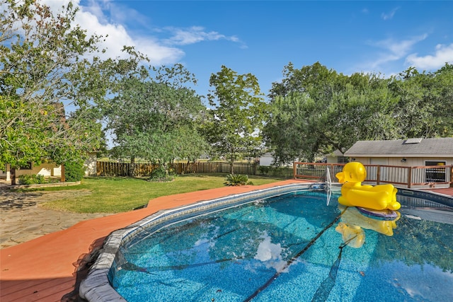 view of pool with a lawn and a patio area