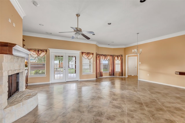 unfurnished living room featuring ceiling fan with notable chandelier, a fireplace, light tile patterned floors, french doors, and ornamental molding