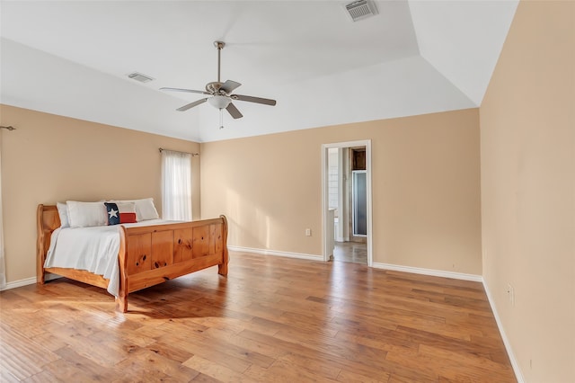 bedroom featuring lofted ceiling, ceiling fan, and light hardwood / wood-style flooring