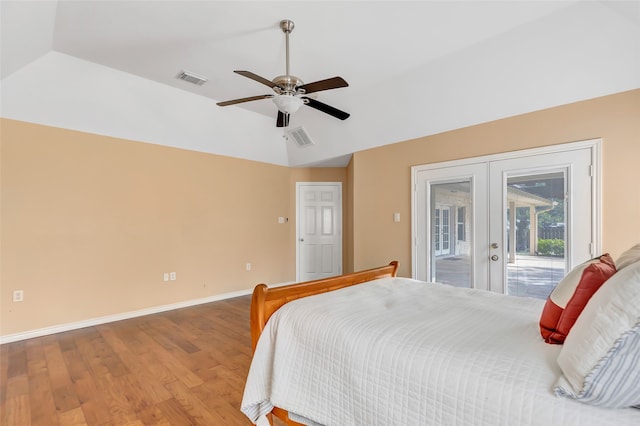 bedroom with vaulted ceiling, access to exterior, ceiling fan, french doors, and hardwood / wood-style flooring