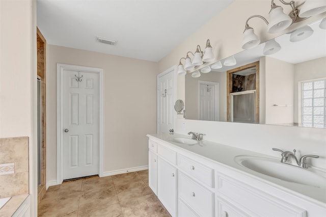 bathroom with vanity, tile patterned floors, and a shower with shower door