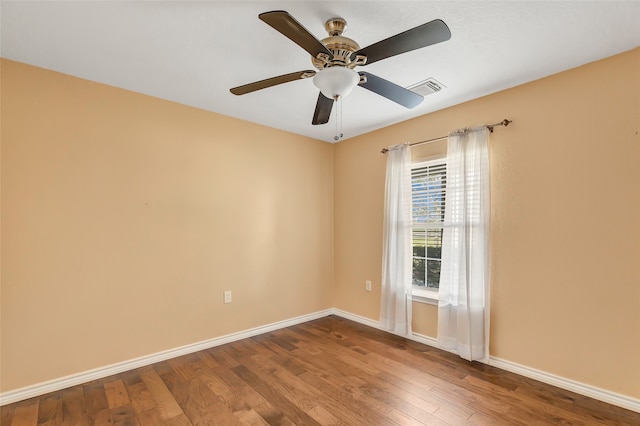 spare room featuring ceiling fan and hardwood / wood-style flooring