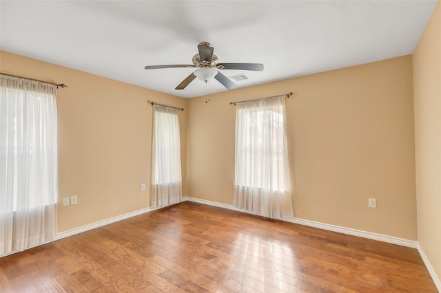 empty room featuring ceiling fan and hardwood / wood-style floors