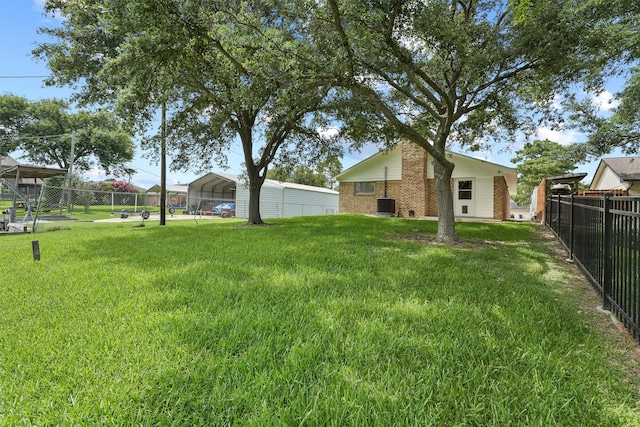 view of yard with a carport and central AC