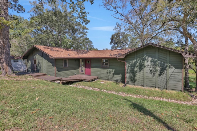 ranch-style house featuring a wooden deck and a front lawn