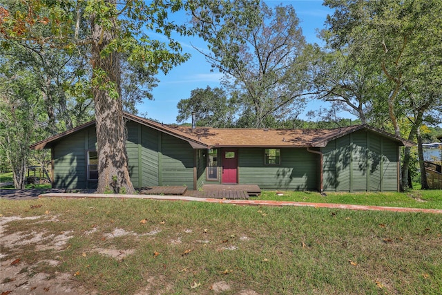 ranch-style home featuring a front yard