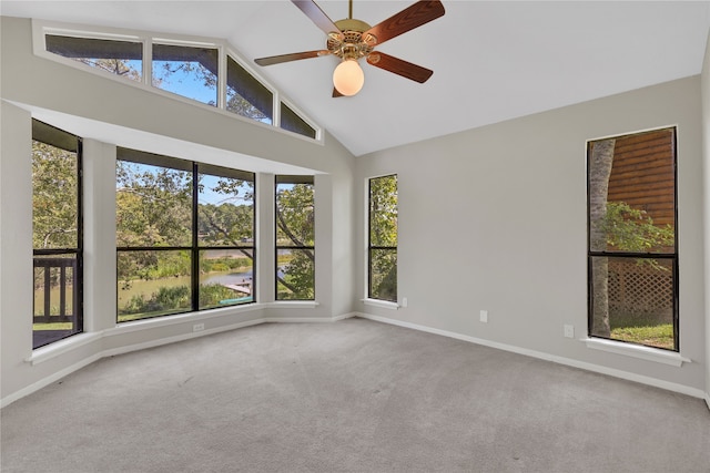 spare room with ceiling fan, carpet flooring, high vaulted ceiling, and a wealth of natural light