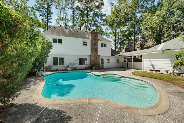 view of swimming pool featuring an in ground hot tub, central AC, and a patio