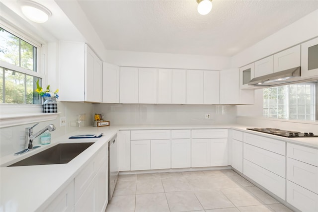 kitchen featuring sink, dishwasher, a textured ceiling, white cabinets, and black gas stovetop