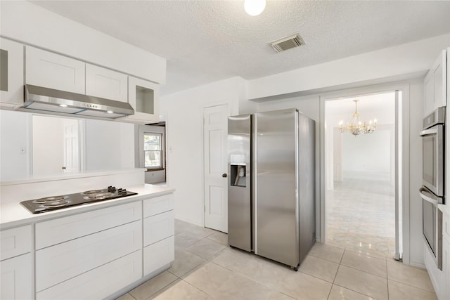 kitchen with stainless steel appliances, white cabinetry, wall chimney range hood, and light tile patterned floors