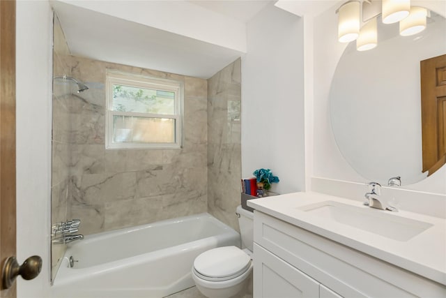 full bathroom featuring tiled shower / bath combo, vanity, and toilet