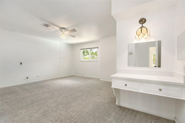 interior space featuring light colored carpet and ceiling fan