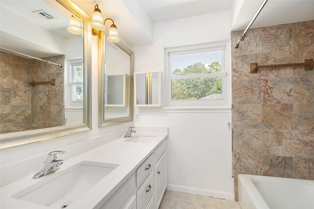 bathroom with vanity, tile patterned floors, and tiled shower / bath