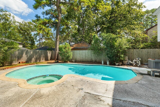 view of pool featuring an in ground hot tub, central AC, and a patio