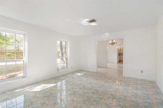 empty room featuring a chandelier