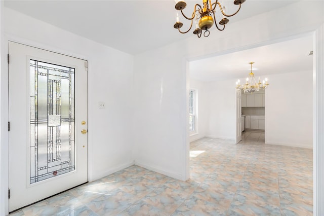 foyer entrance featuring a notable chandelier