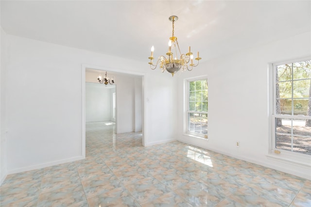 unfurnished room with a healthy amount of sunlight and a chandelier