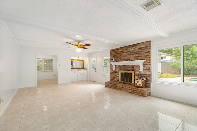 unfurnished living room featuring light tile patterned flooring, beam ceiling, ceiling fan, a brick fireplace, and a textured ceiling