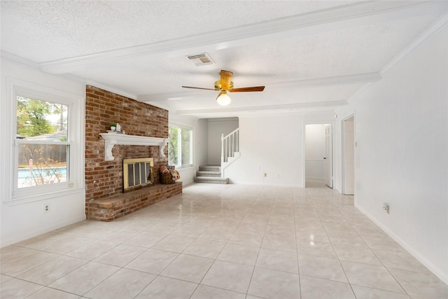 unfurnished living room with beam ceiling, a textured ceiling, a brick fireplace, and light tile patterned floors