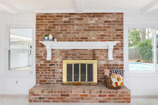 room details with beamed ceiling, ornamental molding, and a fireplace