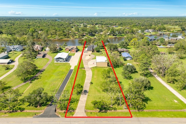 birds eye view of property with a water view