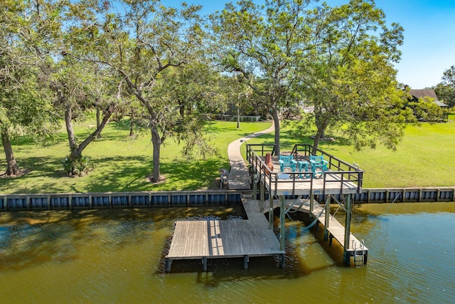 view of dock featuring a water view and a lawn