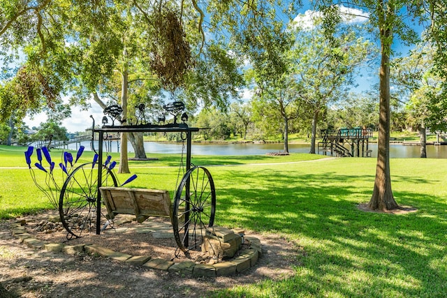 view of property's community featuring a water view and a lawn