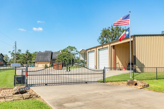 view of gate featuring a lawn