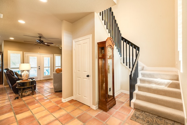 stairs with french doors, tile patterned flooring, and ceiling fan