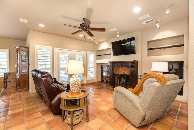 living room with ceiling fan and light tile patterned floors