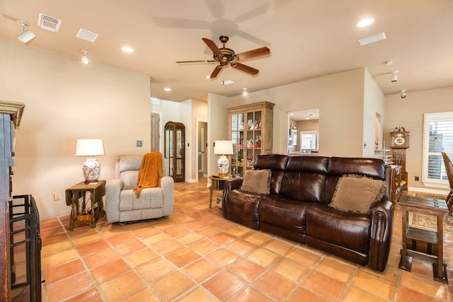 tiled living room featuring ceiling fan