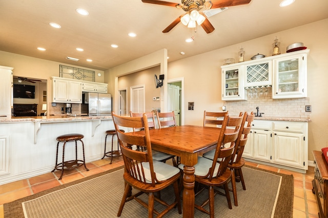 dining space featuring ceiling fan and light tile patterned floors