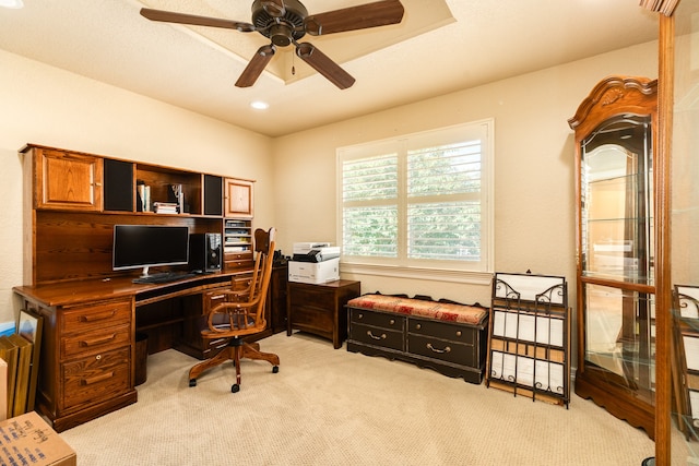 carpeted office space featuring ceiling fan