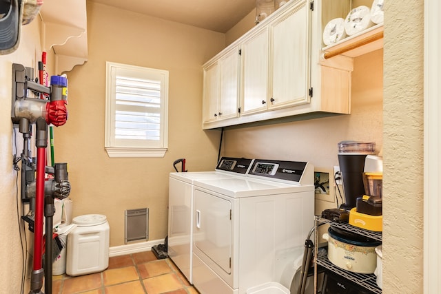 laundry area featuring independent washer and dryer, cabinets, and light tile patterned floors