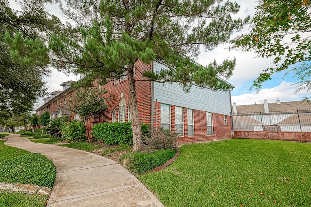 view of side of property with a lawn