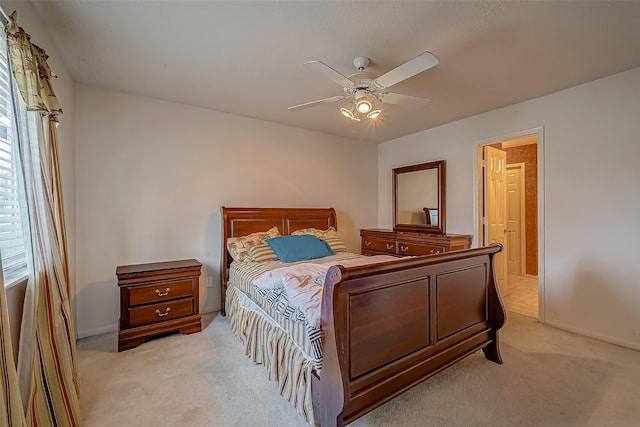 bedroom featuring light carpet, connected bathroom, and multiple windows