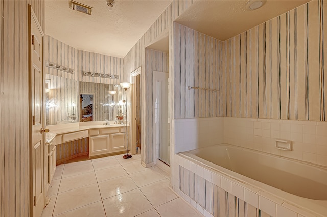 bathroom featuring vanity, a textured ceiling, tile patterned floors, and independent shower and bath