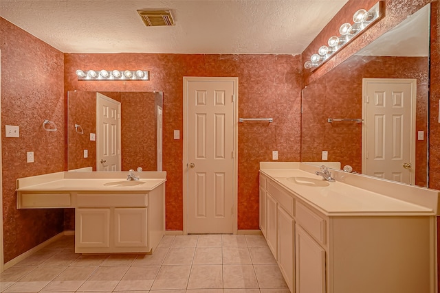 bathroom featuring vanity, a textured ceiling, and tile patterned floors