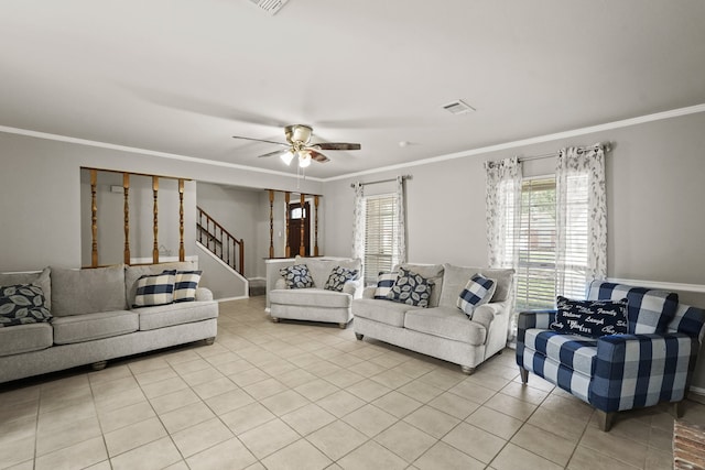 tiled living room featuring ceiling fan, ornamental molding, and a wealth of natural light