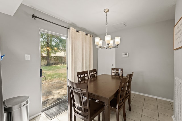 dining area with a notable chandelier and light tile patterned flooring