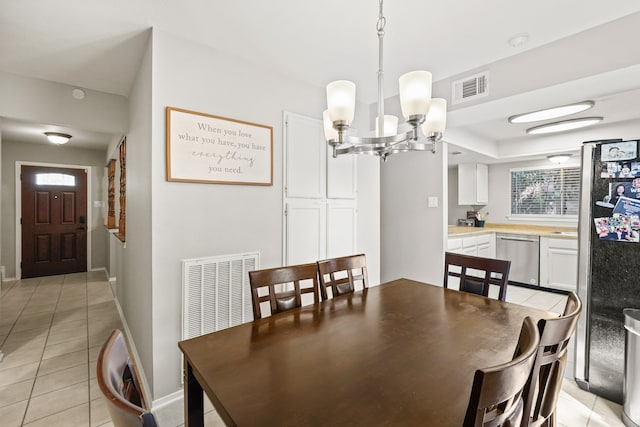 dining area with a chandelier, light tile patterned flooring, and plenty of natural light