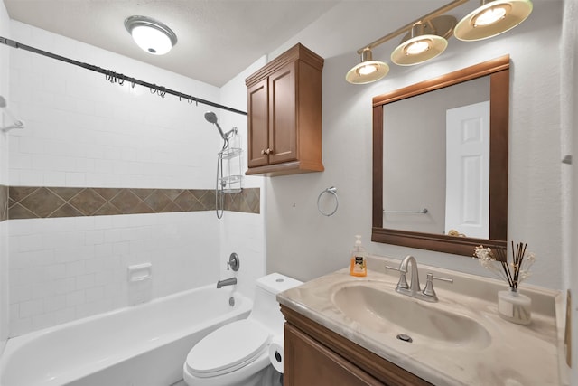 full bathroom featuring a textured ceiling, tiled shower / bath combo, vanity, and toilet