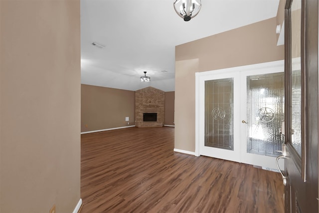 unfurnished living room featuring a fireplace and dark hardwood / wood-style flooring